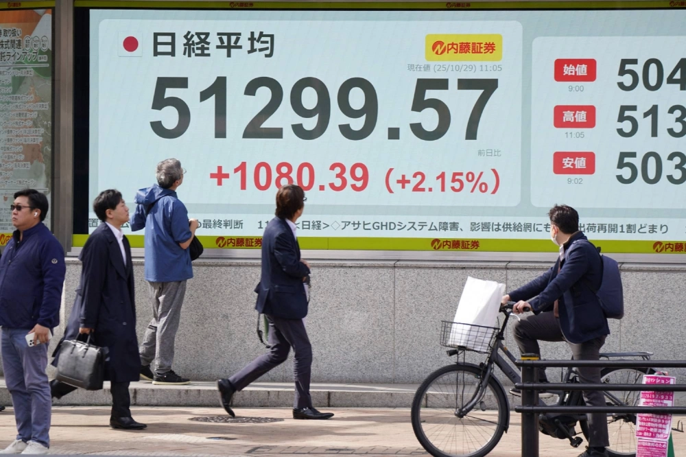 An electronic quotation board in Tokyo shows the Nikkei 225 stock average topping 51,000 on Wednesday. An electronic quotation board in Tokyo shows the Nikkei 225 stock average topping 51,000 on Wednesday.