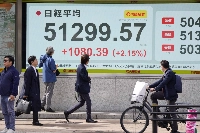 An electronic quotation board in Tokyo shows the Nikkei 225 stock average topping 51,000 on Wednesday. | AFP-JIJI