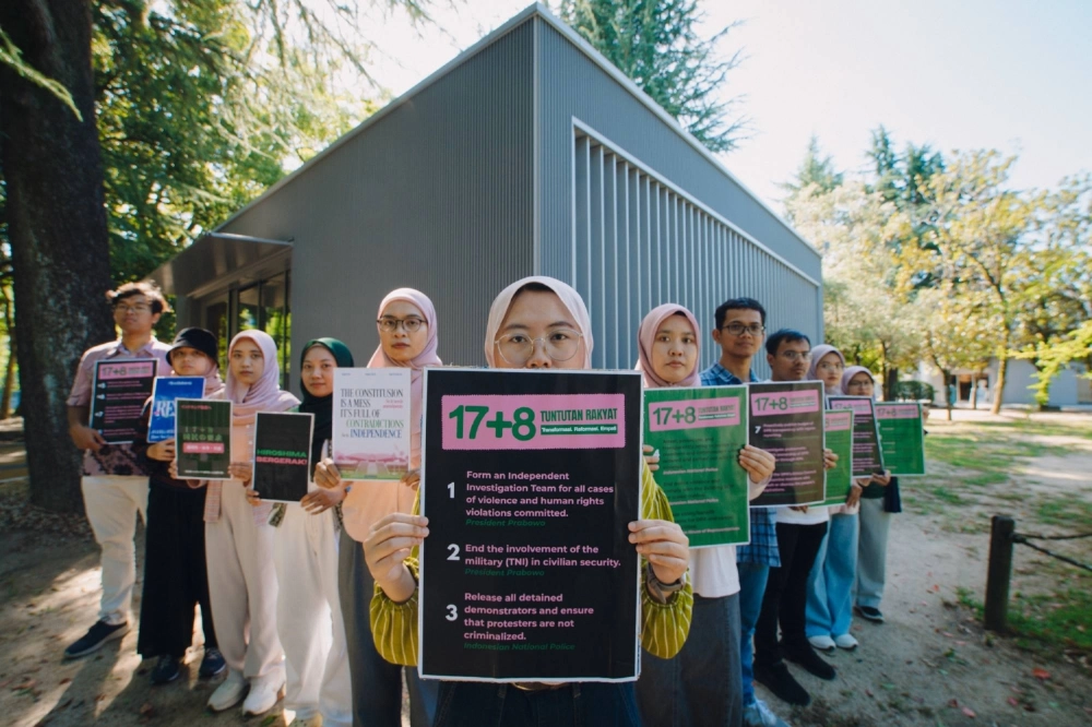 Indonesian students at Hiroshima University hold posters of the 17+8 Demands, demanding transparency and action from their homeland’s government. Indonesian students at Hiroshima University hold posters of the 17+8 Demands, demanding transparency and action from their homeland’s government.