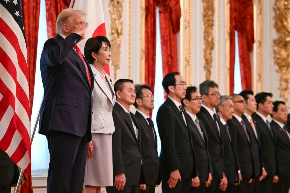 National security adviser Keiichi Ichikawa (fourth from right) is seen on stage as Prime Minister Sanae Takaichi (second from left) and U.S. President Donald Trump (left) review an honor guard of the Self-Defense Forces at the Akasaka State Guest House in Tokyo on Tuesday. National security adviser Keiichi Ichikawa (fourth from right) is seen on stage as Prime Minister Sanae Takaichi (second from left) and U.S. President Donald Trump (left) review an honor guard of the Self-Defense Forces at the Akasaka State Guest House in Tokyo on Tuesday.