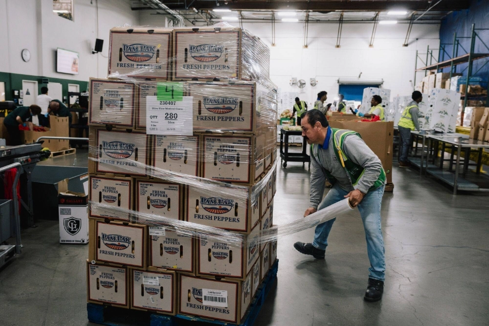Volunteers sort donated food items at the Los Angeles Regional Food Bank's South Los Angeles warehouse on Friday. Volunteers sort donated food items at the Los Angeles Regional Food Bank's South Los Angeles warehouse on Friday.