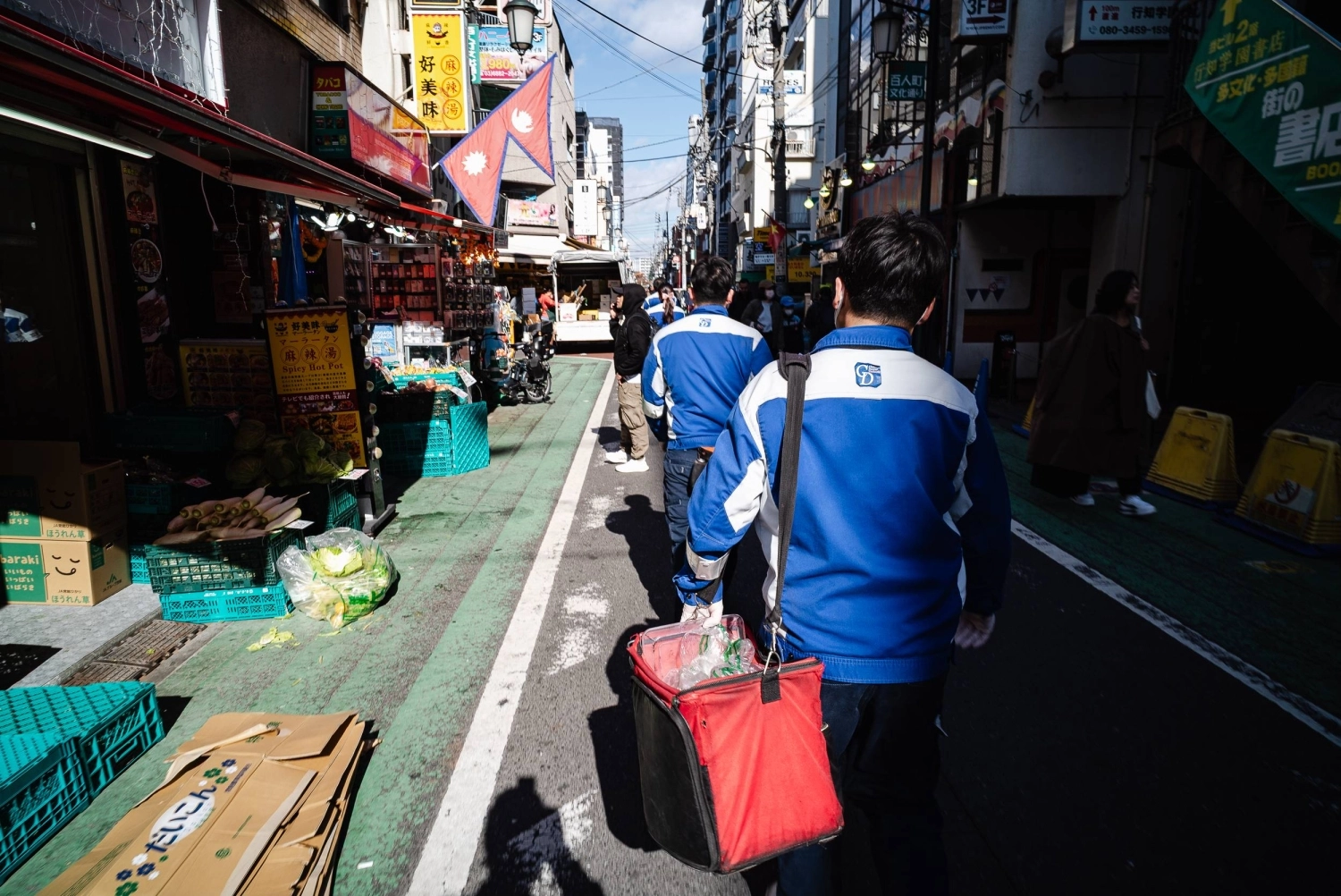 Workers from CIC (Civil International Corporation) head through the streets near JR Shin Okubo Station. Workers from CIC (Civil International Corporation) head through the streets near JR Shin Okubo Station.