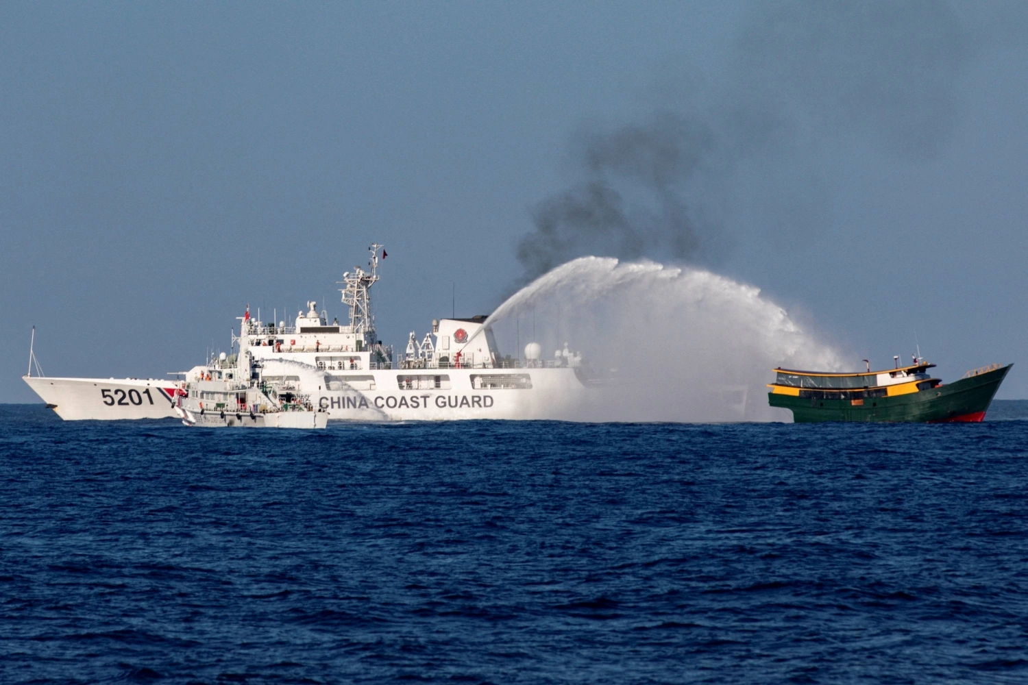 A China Coast Guard vessel fires a water cannon at a Philippine resupply vessel on its way to a resupply mission at Second Thomas Shoal in the disputed South China Sea in March 2024. A China Coast Guard vessel fires a water cannon at a Philippine resupply vessel on its way to a resupply mission at Second Thomas Shoal in the disputed South China Sea in March 2024.
