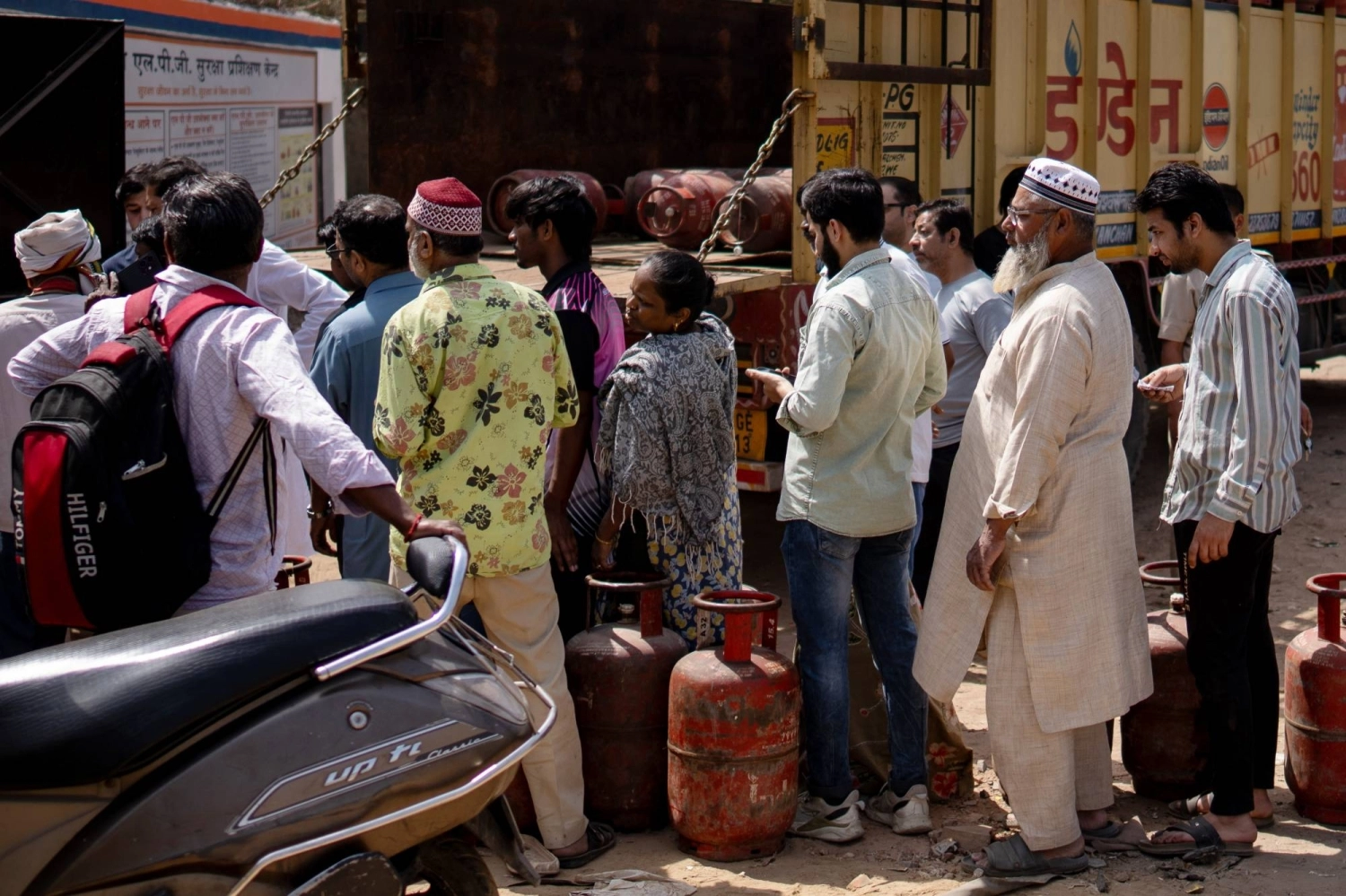 People line up to buy liquefied petroleum gas at a depot in New Delhi on March 16. People line up to buy liquefied petroleum gas at a depot in New Delhi on March 16.