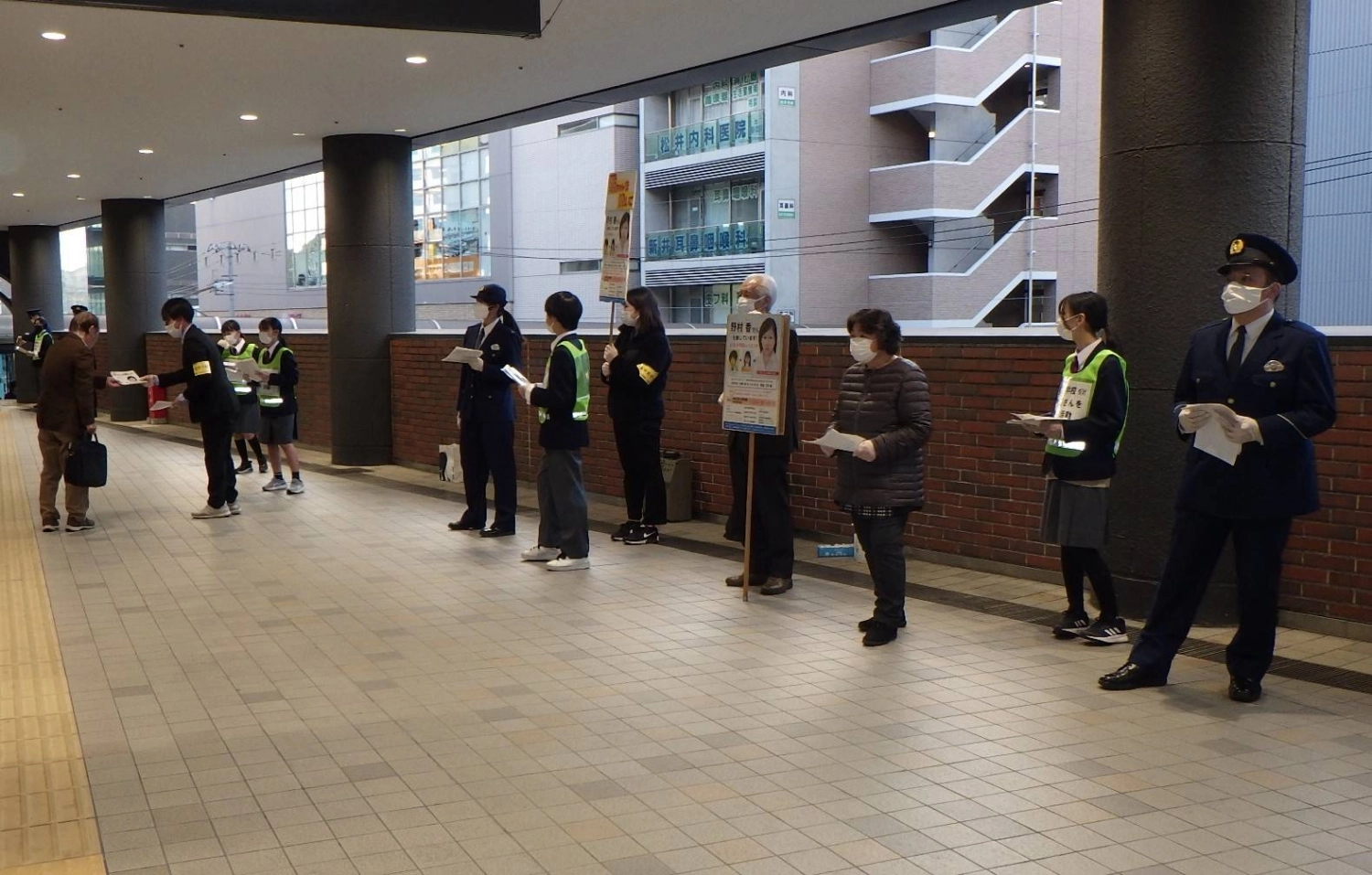 Setsuji Nomura (holding placard) and his wife, Ikuko (third from right), hand out flyers at their local station as they continue their search for their long-lost daughter, Kaori. Setsuji Nomura (holding placard) and his wife, Ikuko (third from right), hand out flyers at their local station as they continue their search for their long-lost daughter, Kaori.