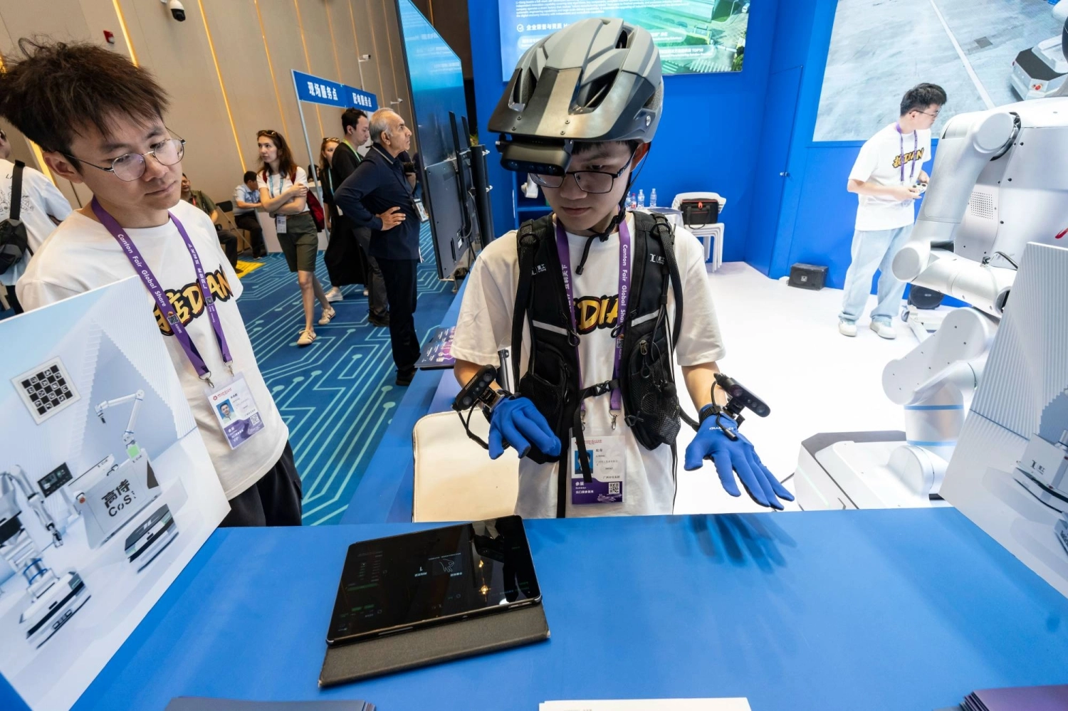 An attendee tries a robot eye-hand coordination tool at the Canton Fair in Guangzhou, China, in April. An attendee tries a robot eye-hand coordination tool at the Canton Fair in Guangzhou, China, in April.