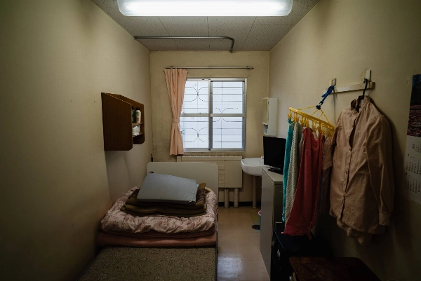 Image 17: Western-style rooms spanning the size of four tatami mats with hardwood floors, a toilet and soft mattresses on bed frames are designated for foreign nationals and those with health conditions at Tochigi Prison.