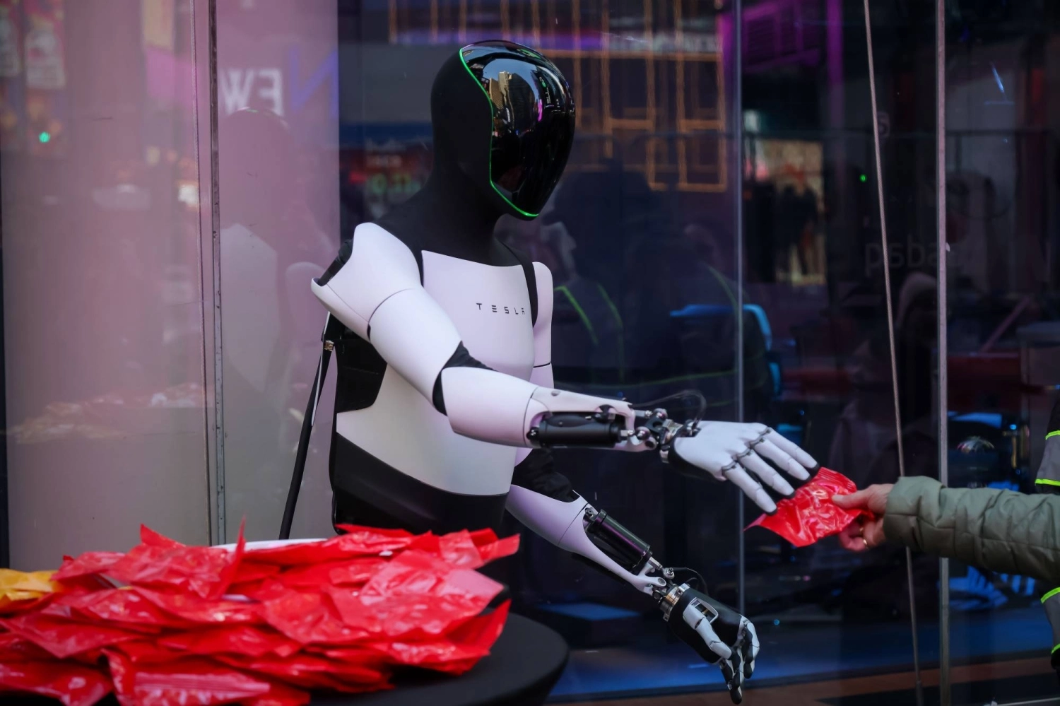 A Tesla Optimus robot hands out candy in front of the Nasdaq MarketSite in New York in 2025.