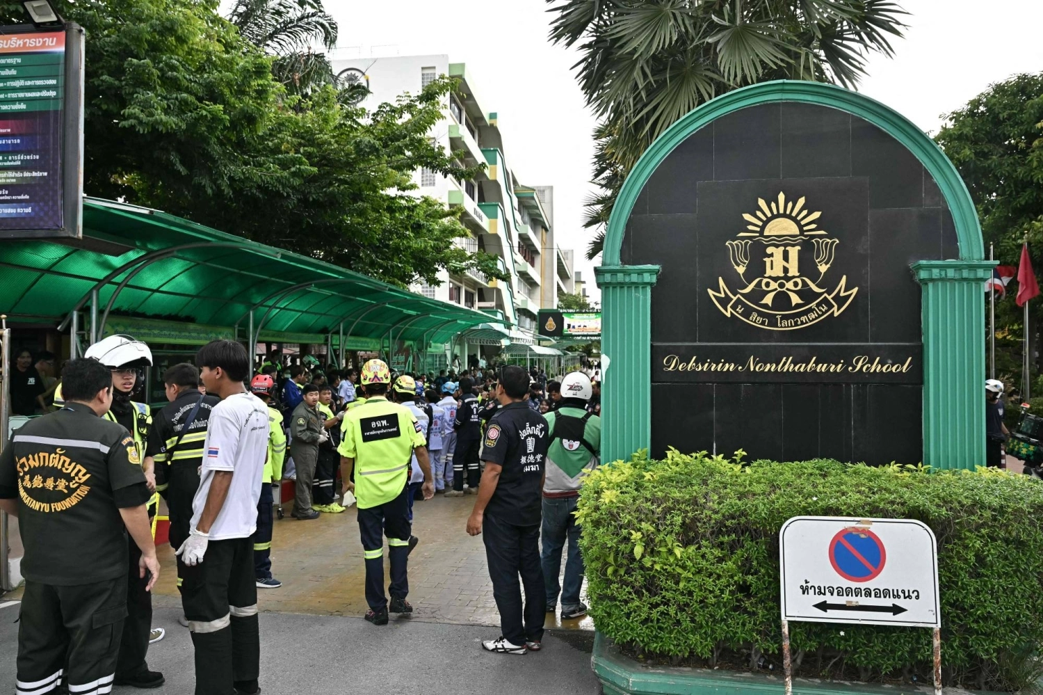 Emergency responders stand outside Debsirin Nonthaburi School on Friday.