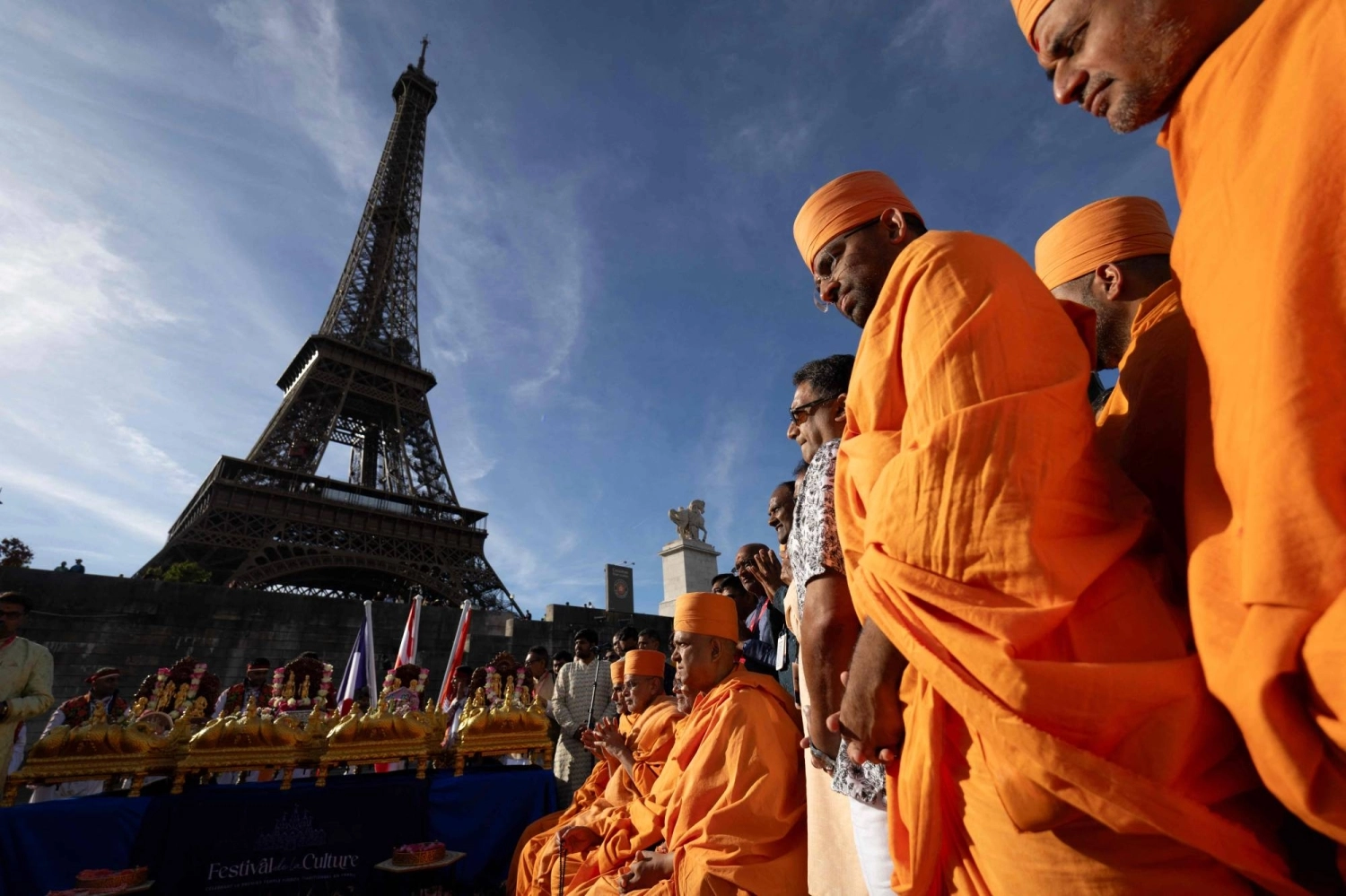 Bochasanwasi Akshar Purushottam Swaminarayan Sanstha (BAPS) Hindu monks take part in a religious ceremony in front of the Eiffel Tower before a ceremonial river parade on the river Seine in Paris on Sept. 3.