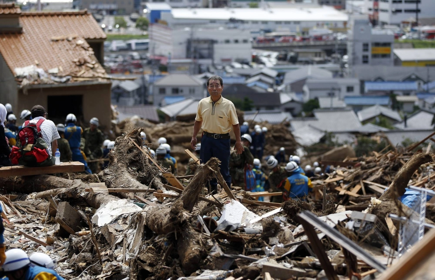 A local resident stands amid rubble where a landslide swept through a residential area in the city of Hiroshima's Asaminami Ward in August 2014, after landslides triggered by torrential rain slammed into the outskirts of the city, leaving 77 dead. A local resident stands amid rubble where a landslide swept through a residential area in the city of Hiroshima's Asaminami Ward in August 2014, after landslides triggered by torrential rain slammed into the outskirts of the city, leaving 77 dead.