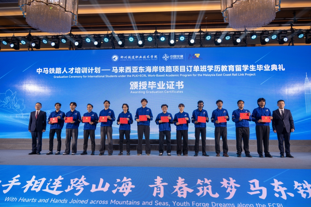 Some of the graduates of the Batch 1 East Coast Rail Link (ECRL) Industrial Skills Training Programme (PLKI-ECRL) for Operations and Maintenance (O&M) Training pose for a group photograph on stage during their graduation ceremony at Liuzhou Railway Vocational Technical College (LRVTC) in Liuzhou May 20, 2026. — Bernama pic