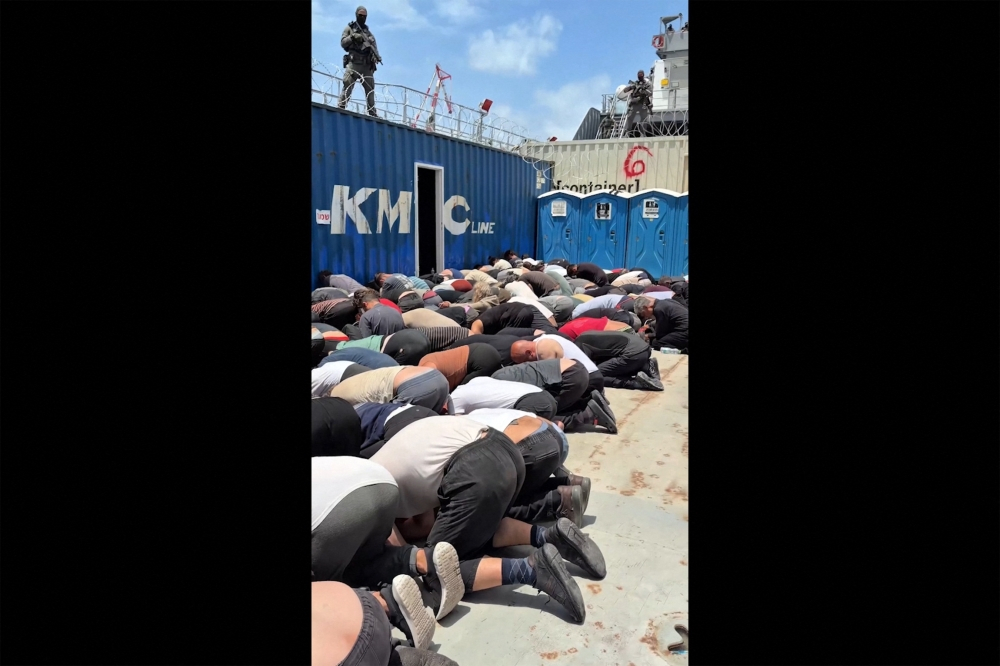 Putrajaya demands investigation into Malaysians detained by Israel in Gaza flotilla mission, insists rights and dignity be protected Screen grab from Israeli minister Itamar Ben Gvir’s X account on May 20, 2026 shows Gaza‑bound flotilla activists kneeling with hands tied on a military boat. — AFP pic/X account of Israel’s National Security Minister Itamar Ben Gvir