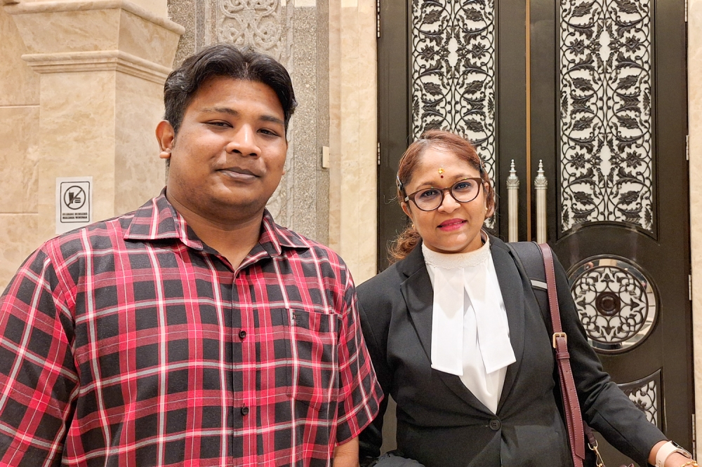 Perak-born man loses citizenship appeal despite having Malaysian father and passport Haritharan Mugunthan is seen with his lawyer R. Renuga Ramayah at the Palace of Justice in Putrajaya on January 21, 2026. — Picture by Ida Lim