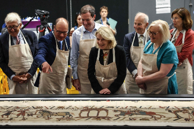 British Museum reveals sections of Bayeux Tapestry after its ‘titanic’ journey to London France's Culture Minister Catherine Pégard (C) listens to Michael Lewis (2nd L), lead curator of the exhibition, during a visit to the unveiling of the Bayeux Tapestry at the British Museum in central London yesterday. — AFP pic