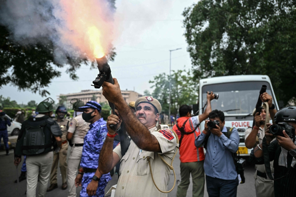 Indian police fire tear gas as thousands of protesters demand action over exam leaks | Malay Mail
