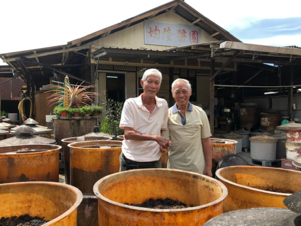 For nearly a century, this Penang family in Jelutong has let the sun make its soy sauce Kam Kam Yoon (right) and his brother Kam Pak Yuen at the San Kwan Loong soy sauce factory in Jelutong, Penang. — Picture courtesy of Penang Global Tourism