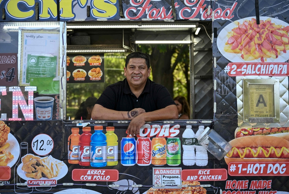 Food vendor William Arevalo poses for a picture in his electric battery powered food cart in Flushing Meadows-Corona Park on July 23, 2026 in New York City. Walk around New York and you’ll likely hear the chugging of petrol generators powering the city’s tens of thousands of food carts. But not William Arevalo’s. — AFP pic
