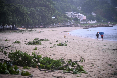 Flash flood at north-west China tourist site kills 10, injures 23 as heavy rain triggers alerts across southern region People walk on a beach with debris from Typhoon Noul which passed close to Hong Kong July 26, 2026. A flash flood caused by heavy rain struck a tourist site in north-west China today, killing 10 people and injuring 23 while large swaths of southern China are on high alert for floods today after Typhoon Noul made landfall early in the morning. — AFP pic