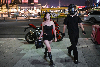 Neon, superbikes and slow motion: Tourists flock to Chongqing’s cyberpunk streets for a 200-yuan night rider fantasy A woman poses for picture with a motorcycle rider offering photo and video service along a street in Chongqing July 20, 2026. — AFP pic
