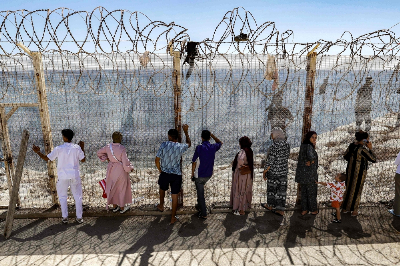 ‘Warning to Spain’: Did Morocco deliberately trigger the Ceuta migrant surge? Relatives and friends wait by a fence topped with barbed wire for the return of people who had previously crossed into Spain’s North African enclave of Ceuta, at Morocco’s Bab Sebta border crossing on the outskirts of Fnideq on August 2, 2026. — AFP pic