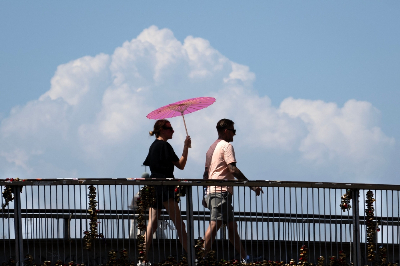 AFP: Record July heat in regions home to 900 million people A woman walks holding an umbrella to shield from the sun during a heatwave in Rome at the Colosseum, on August 6, 2026. — AFP pic