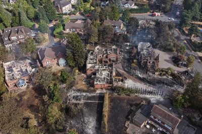 UK firefighters battle wildfires as heatwave leaves homes scorched, thousands at risk An aerial view shows smoke rising from fire-damaged houses, south of Stourbridge town centre in central England on August 14, 2026. — AFP pic