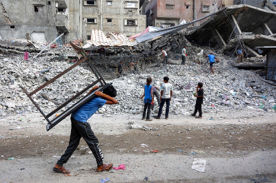 ‘American Doctor’ shows brutality of conflict in Gaza A boy walks carrying a table on his back past salvage workers scrapping the rubble of a building that was destroyed during Israel's war against Hamas in Gaza, to use the recycled remains in the future, in Gaza City on August 16, 2026. The Palestinian Islamist group Hamas had said on August 15 that it asked the US-backed Board of Peace to