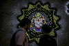 Penang leaves fate of agency chairman under corruption probe to Putrajaya Two people walk past the Malaysian Anti-Corruption Commission (MACC) logo at its headquarters in Putrajaya on July 3, 2018. — Picture by Hari Anggara