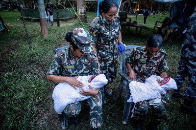 At least 10,000 families homeless after devastating Nepal floods Nepali Army personnel comfort twin infants during rescue operations after flash floods at Trishuli camp in Nepal’s Nuwakot district on August 27, 2026. — AFP pic
