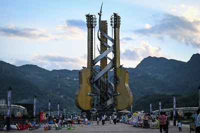 China’s guitar capital Zheng’an builds a stairway to export heaven after decade‑long manufacturing boom This photo taken on July 26, 2026 shows people walking past a giant installation of guitars at the Guitar Cultural Plaza in Zheng’an, in south-western China’s Guizhou Province. The town of Zheng’an in the southwest province of Guizhou produces one in every seven of the instruments sold worldwide — but a decade ago, it had no guitar-making industry to speak of at all. — AFP pic