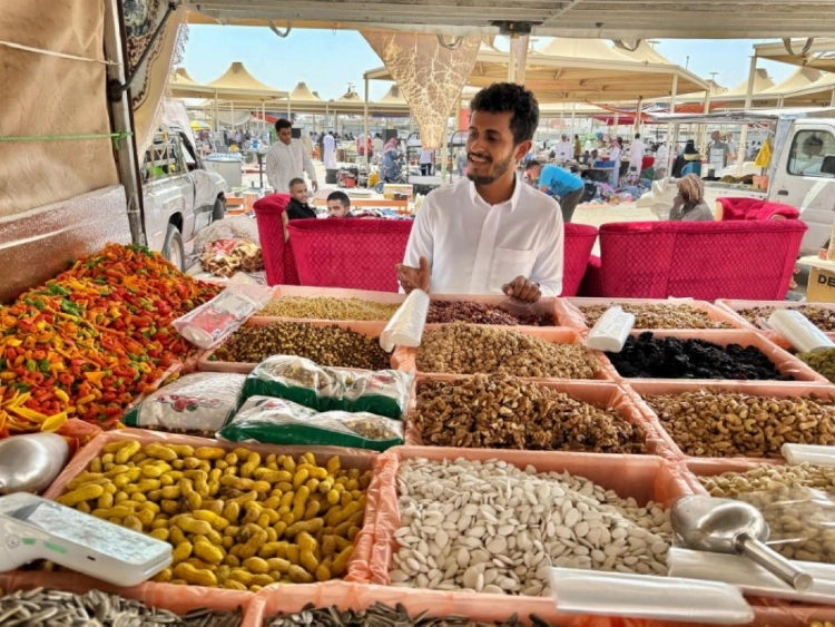 البائع سالم الحويطي يستعرض المكسرات التي تشهد اقبالاً كبيرا من الأهالي والمقيمين في سوق السبت بتبوك. (تصوير :علي بدير)