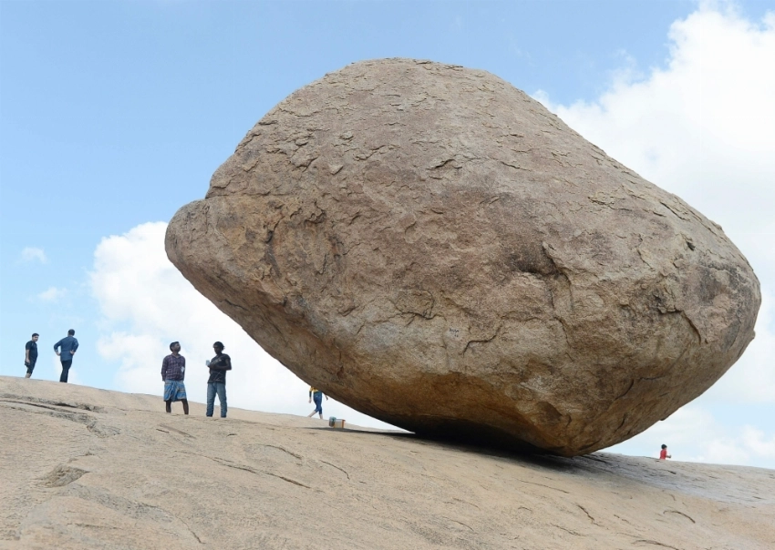 ROCK AND NOT ROLL Visitors stand beside the granite boulder 'Krishna's Butterball' at Mahabalipuram on Thursda. The world heritage site of Mahabalipuram could be one of the ports of call for Chinese President Xi Jinping when he holds a summit with his Indian counterpart Narendra Modi reported by Indian media to be held from Oct. 11-13 in the southern state of Tamil Nadu state. — AFP